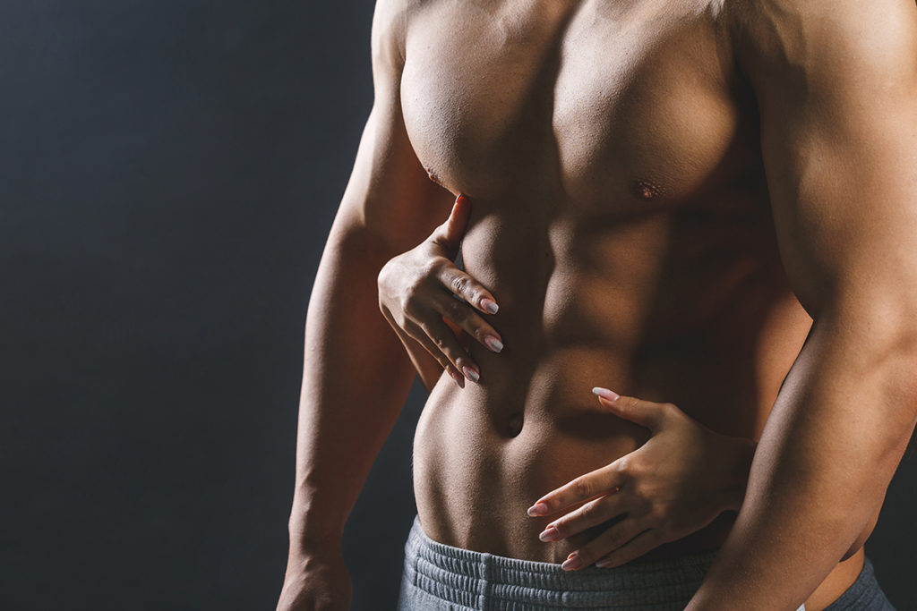 strong male abs with female hands