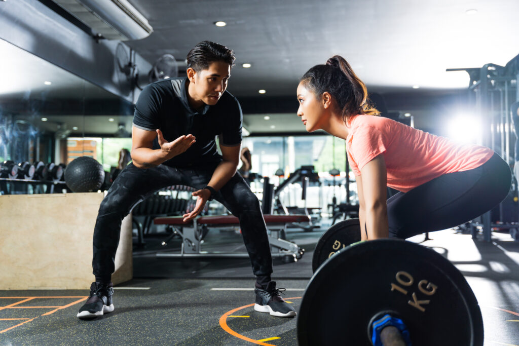 personal trainer - woman lifting weights